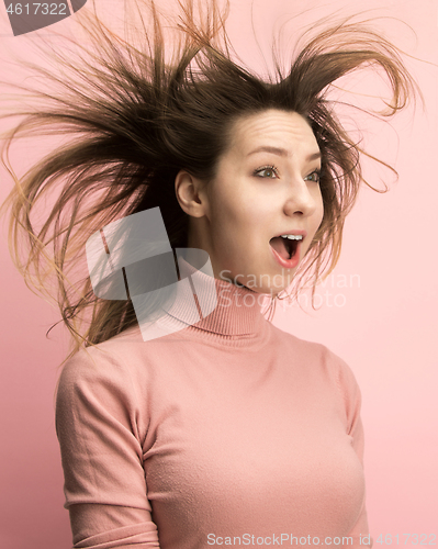 Image of The woman screaming with open mouth isolated on pink background, concept face emotion