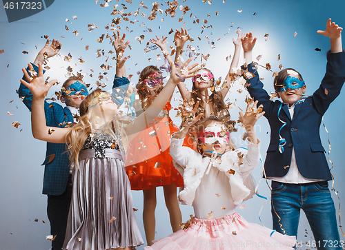 Image of Adorable kids have fun together, throw colourful confetti,