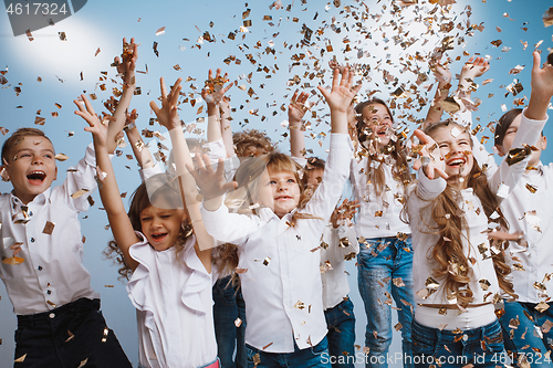 Image of Adorable kids have fun together, throw colourful confetti,