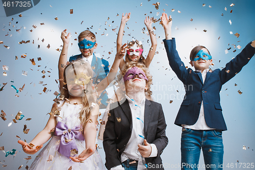 Image of Adorable kids have fun together, throw colourful confetti,