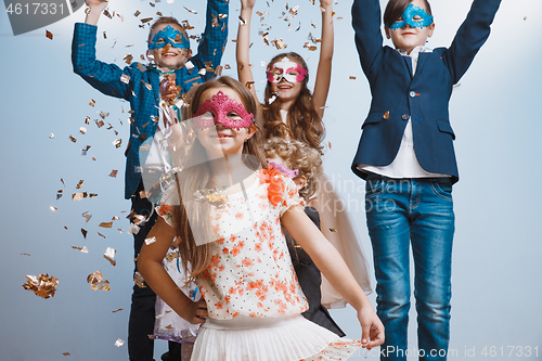 Image of Adorable kids have fun together, throw colourful confetti,