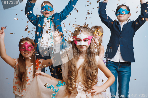 Image of Adorable kids have fun together, throw colourful confetti,
