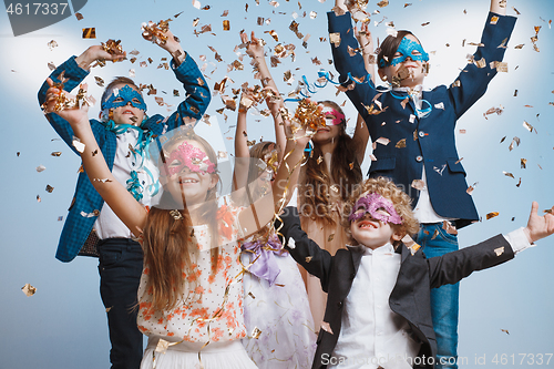 Image of Adorable kids have fun together, throw colourful confetti,