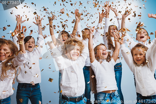 Image of Adorable kids have fun together, throw colourful confetti,