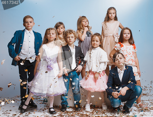 Image of Adorable kids have fun together, throw colourful confetti,