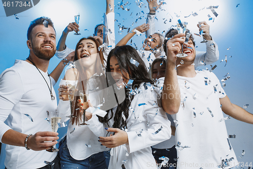 Image of Group of cheerful joyful young people standing and celebrating t