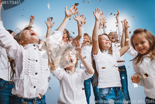 Image of Adorable kids have fun together, throw colourful confetti,