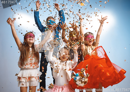 Image of Adorable kids have fun together, throw colourful confetti,