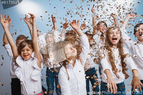 Image of Adorable kids have fun together, throw colourful confetti,