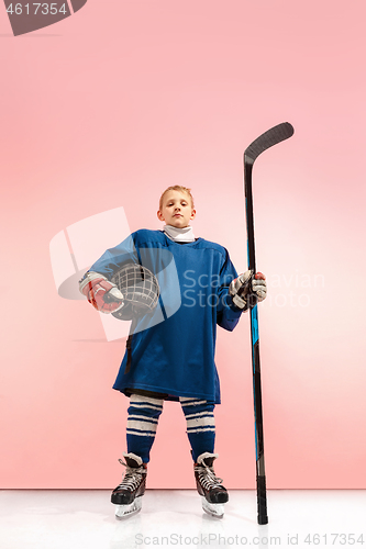 Image of A hockey player with equipment over a pink background