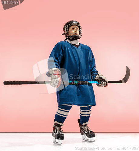 Image of A hockey player with equipment over a pink background