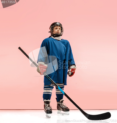 Image of A hockey player with equipment over a pink background