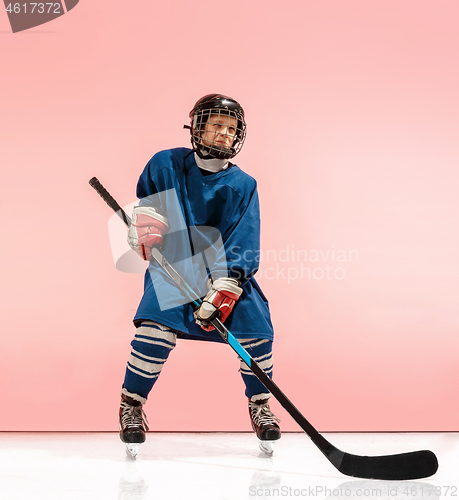 Image of A hockey player with equipment over a pink background