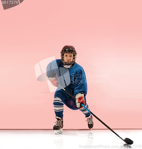 Image of A hockey player with equipment over a pink background