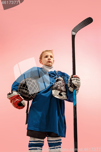 Image of A hockey player with equipment over a pink background