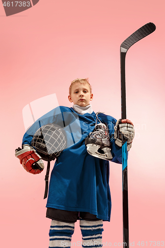 Image of A hockey player with equipment over a pink background