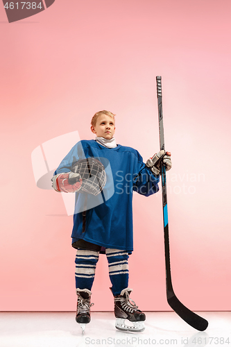 Image of A hockey player with equipment over a pink background