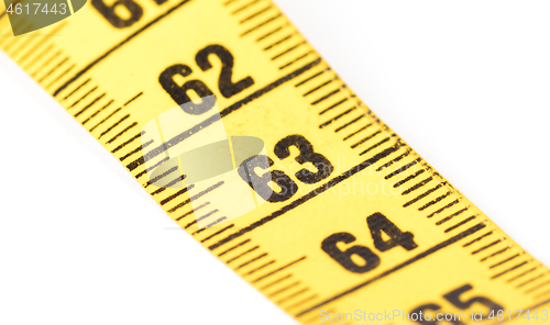 Image of Close-up of a yellow measuring tape isolated on white - 63