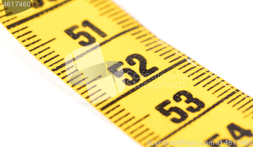 Image of Close-up of a yellow measuring tape isolated on white - 52