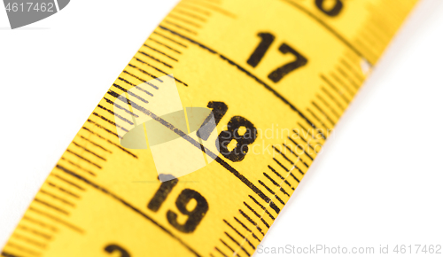 Image of Close-up of a yellow measuring tape isolated on white - 18