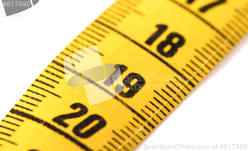 Image of Close-up of a yellow measuring tape isolated on white - 19