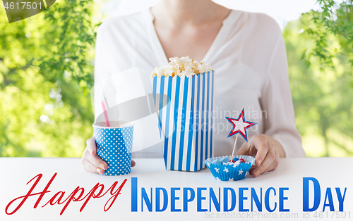 Image of woman eating popcorn with drink and candies