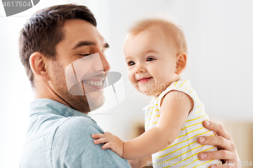 Image of father with little baby daughter at home