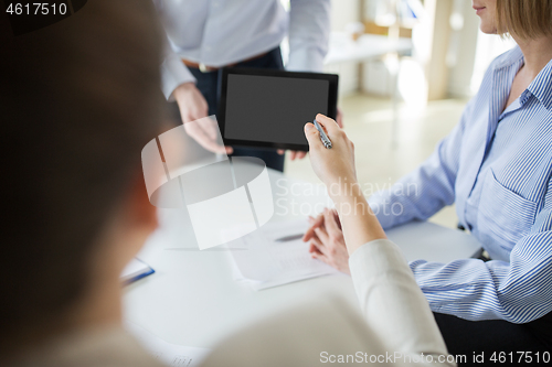 Image of close up of business team with tablet pc at office