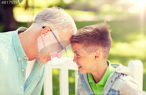 Image of grandfather and grandson at summer park