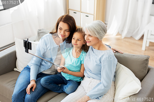 Image of mother, daughter and grandmother taking selfie