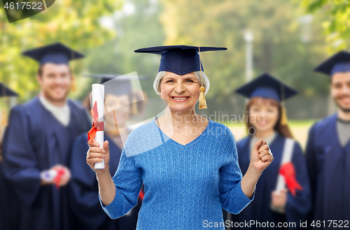 Image of happy senior graduate student woman with diploma