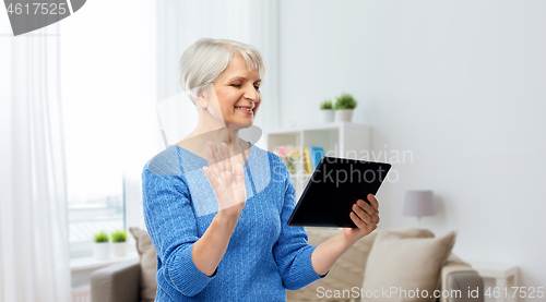 Image of senior woman having video call on tablet computer
