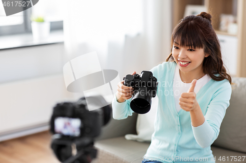 Image of asian female blogger with camera recording video