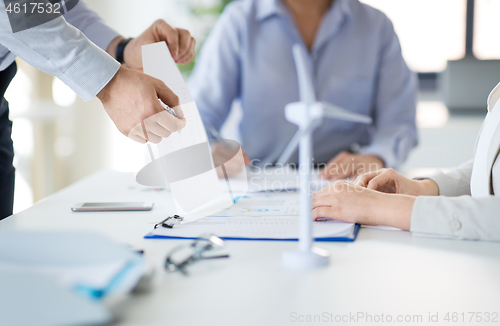 Image of business team discussing report at office