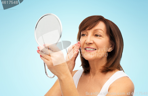 Image of portrait of smiling senior woman with mirror