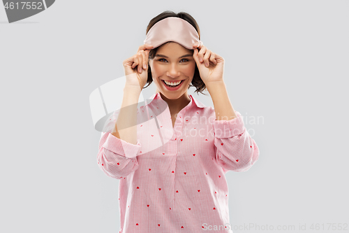 Image of happy young woman in pajama and eye sleeping mask