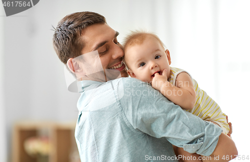 Image of happy father holding little baby daughter at home