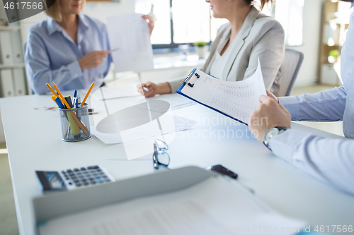 Image of business team discussing report at office