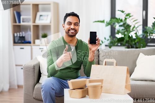 Image of indian man using smartphone for food delivery