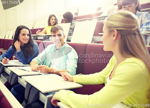 Image of group of students with notebooks at lecture hall