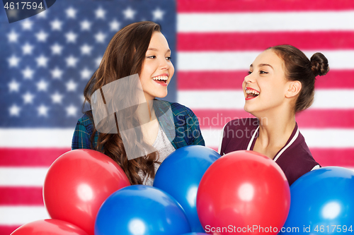 Image of teenage girls with balloons over american flag