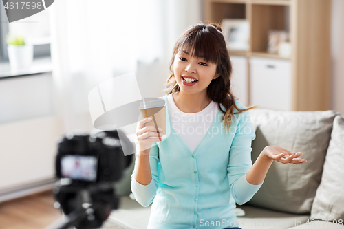 Image of asian female blogger with coffee recording video