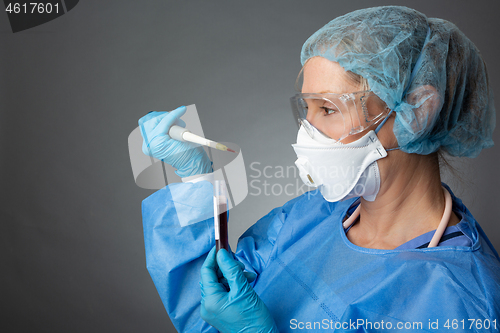 Image of Laboratory healthcare worker holding a pipette blood sample