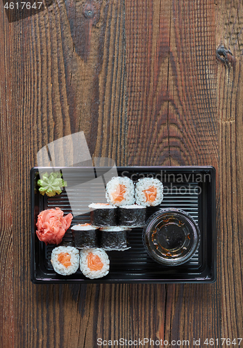 Image of salmon sushi in plastic box