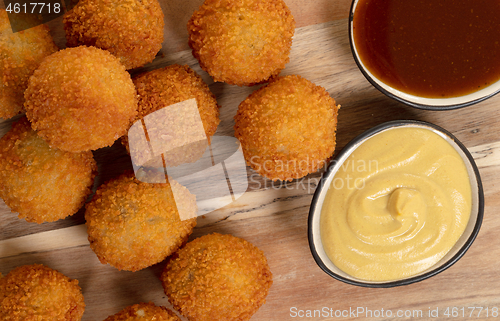 Image of Dutch traditional snack bitterbal on a serving board