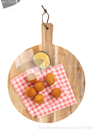 Image of Dutch traditional snack bitterbal on a serving board