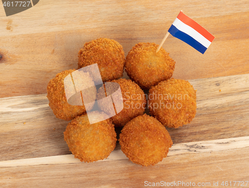 Image of Dutch traditional snack bitterbal on a serving board, dutch flag