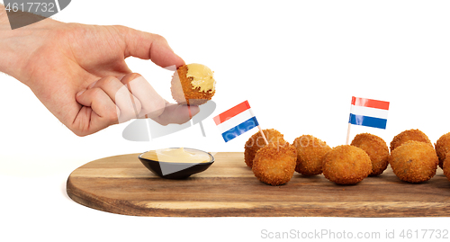 Image of Dutch traditional snack bitterbal in a hand