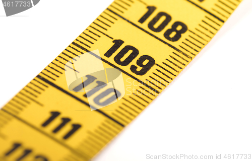 Image of Close-up of a yellow measuring tape isolated on white - 109