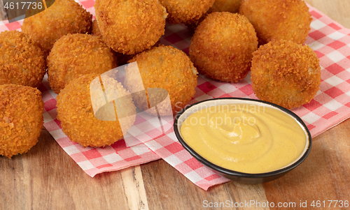 Image of Dutch traditional snack bitterbal on a serving board